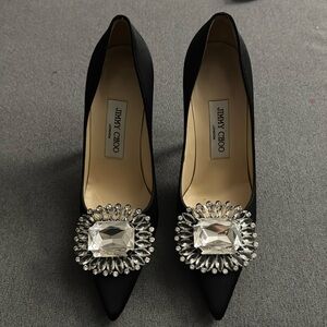 Jimmy Choo Black Satin Pumps with front embellishment.